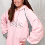 Girl wearing Stitches pink hoodie